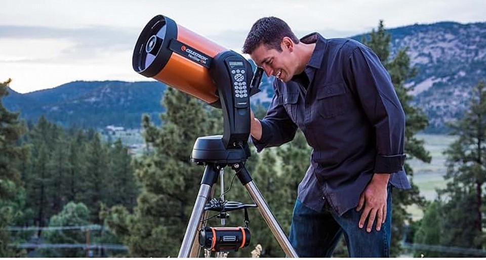 Man looking through very expensive Celestron telescope ( Image credit amazon)